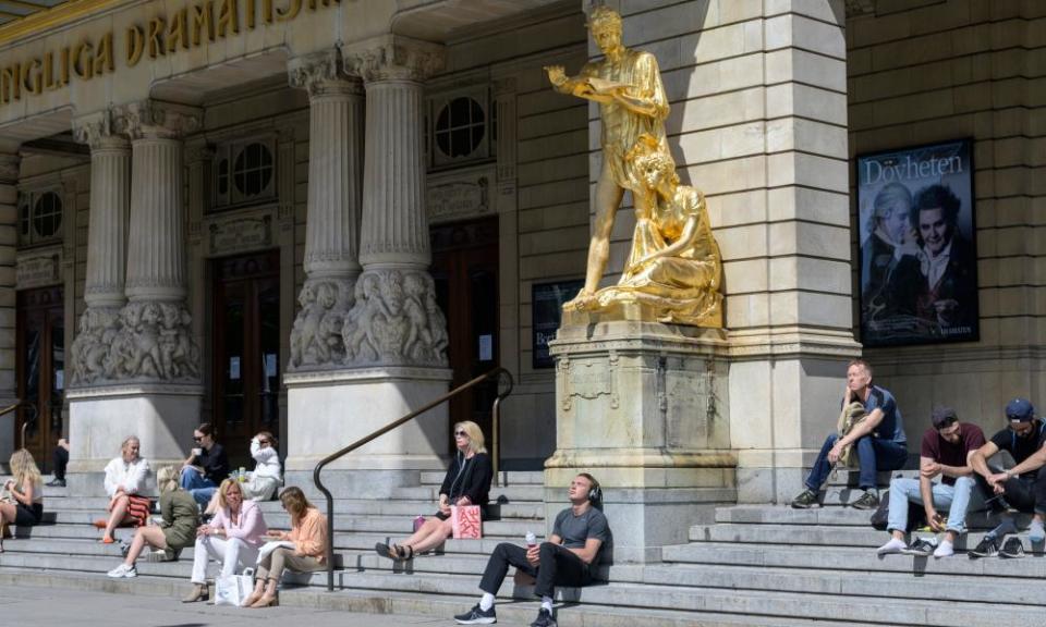 People enjoy sunny weather sitting on the stairs of the Royal Dramatic Theatre, Stockholm.