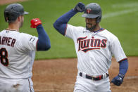 Minnesota Twins' Byron Buxton celebrates with Mitch Garver (8) his solo home run against the Seattle Mariners in the fifth inning of a baseball game Thursday, April 8, 2021, in Minneapolis. The Twins won 10-2. (AP Photo/Bruce Kluckhohn)