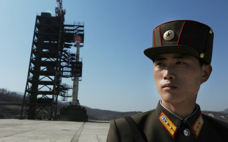 A North Korean soldier stands guard in front of an Unha-3 rocket at the Sohae Satellite Launch Station in Tongchang-Ri on April 8, 2012