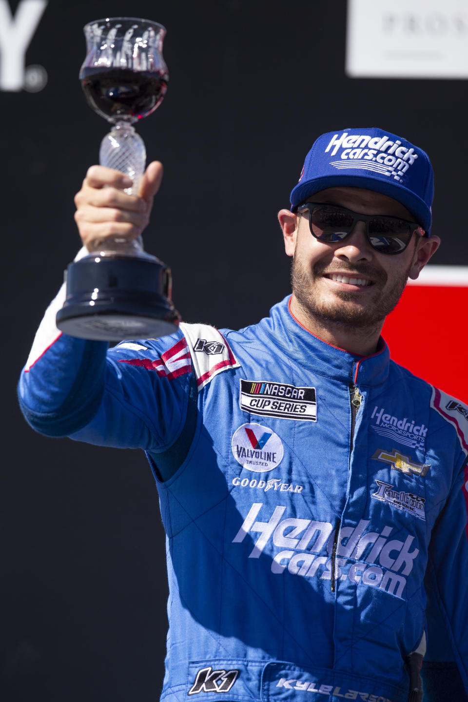 FILE - Kyle Larson celebrates his victory in a NASCAR Cup Series race at Sonoma Raceway in Sonoma, Calif., in this Sunday, June 6, 2021, file photo. Rick Hendrick gave Kyle Larson a second chance in NASCAR because Hendrick Motorsports had wanted him in its lineup for years. Now that Hendrick has his man, he's locked Larson down for two more seasons with full sponsorship. Hendrick on Wednesday, July 14, told his 93 dealerships that the hottest driver in motorsports signed a contract extension through 2023 and Larson will be fully sponsored by HendrickCars.com. (AP Photo/D. Ross Cameron, File)