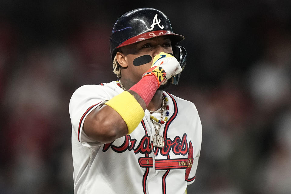 Atlanta Braves right fielder Ronald Acuna Jr. (13) walks to first during the eighth inning of Game 1 of a baseball NL Division Series against the Philadelphia Phillies, Saturday, Oct. 7, 2023, in Atlanta. (AP Photo/Brynn Anderson)