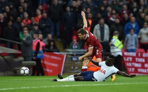 Davinson Sanchez slides in to thwart James Milner - Credit: John Powell/Liverpool FC via Getty Images