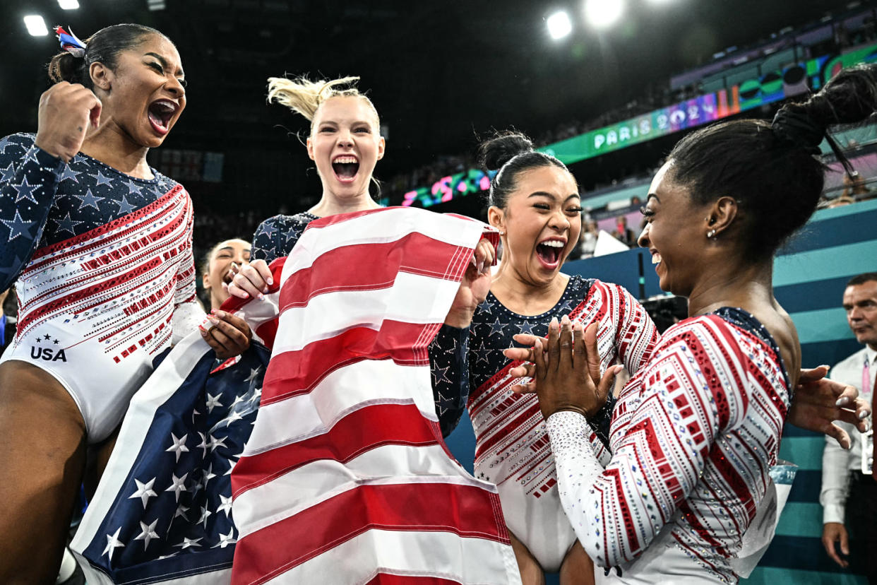 Image: US' Simone Biles and teammates celebrate (Lionel Bonaventure / AFP - Getty Images)