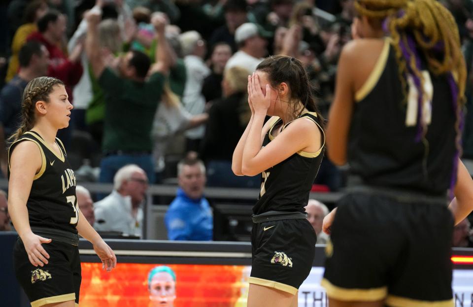 Lapel Bulldog Madelyn Poynter (21) (center) holds her face in her hands after the team lost the IHSAA Class 2A championship game to Forest Park, 37-38, Saturday, Feb. 25, 2023, at Gainbridge Fieldhouse in Indianapolis. 