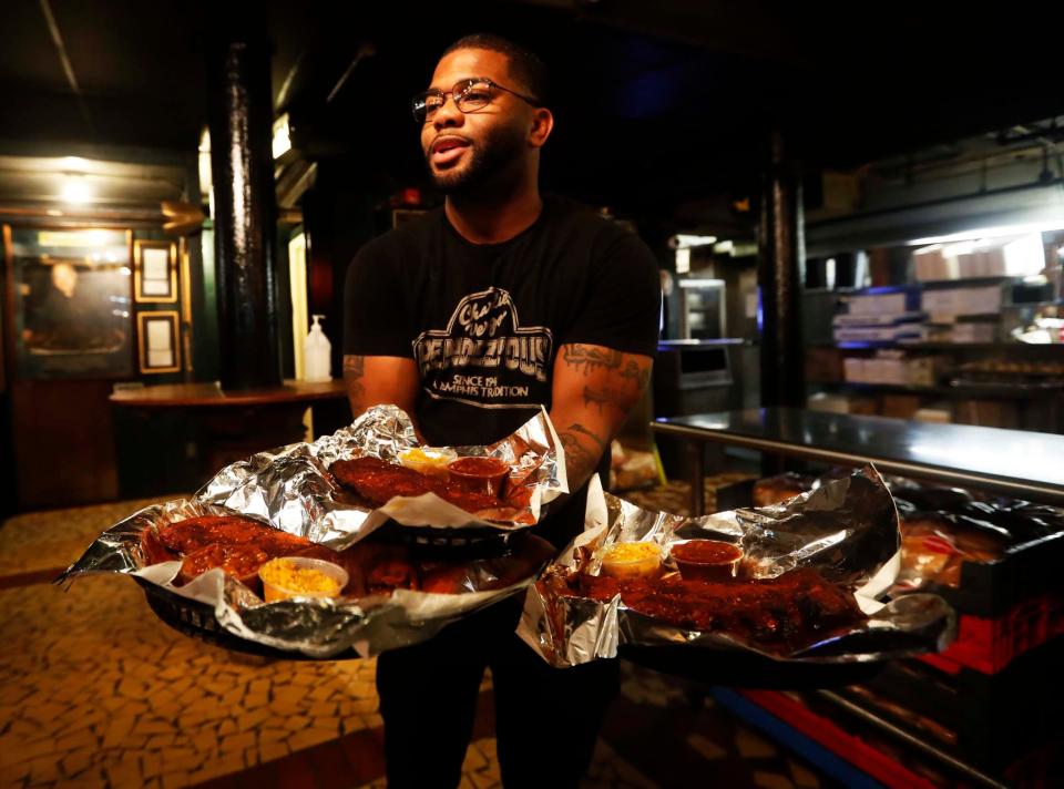 Pit master Robert Cox holds a tray of ribs inside The Rendezvous in Downtown Memphis on Sept. 26, 2023. The charbroiled ribs at The Rendezvous are world-famous.