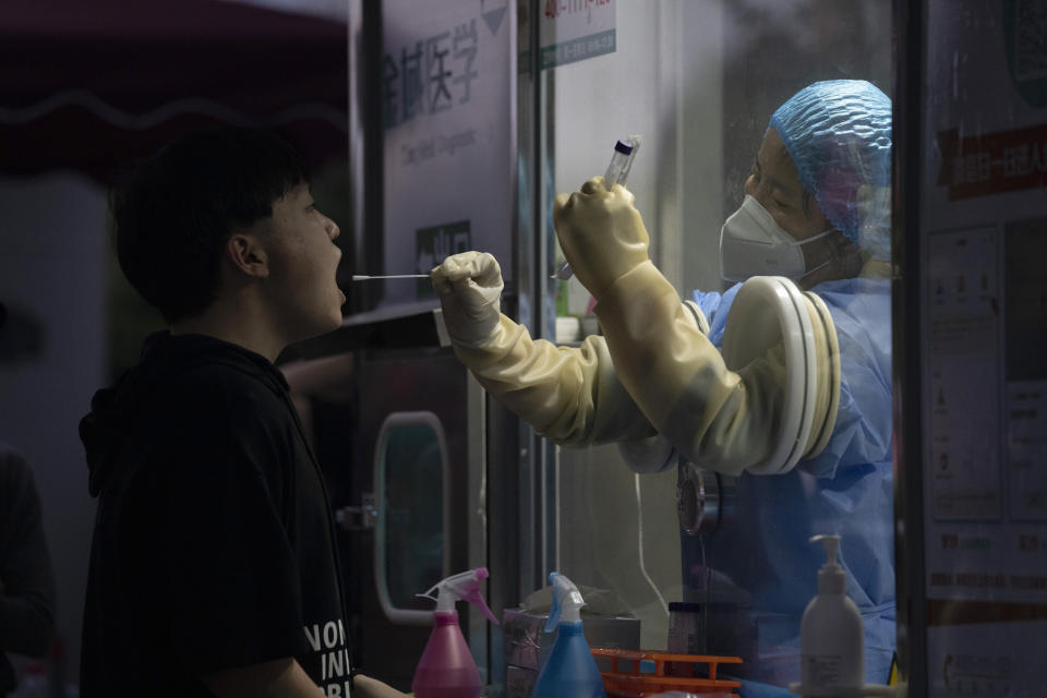 A man gets swapped during a nuclei test for COVID-19 in Beijing Saturday, Sept. 18, 2021. China's "zero tolerance" strategy of trying to isolate every case and stop transmission of the coronavirus has kept kept the country where the virus first was detected in late 2019 largely free of the disease. (AP Photo/Ng Han Guan)