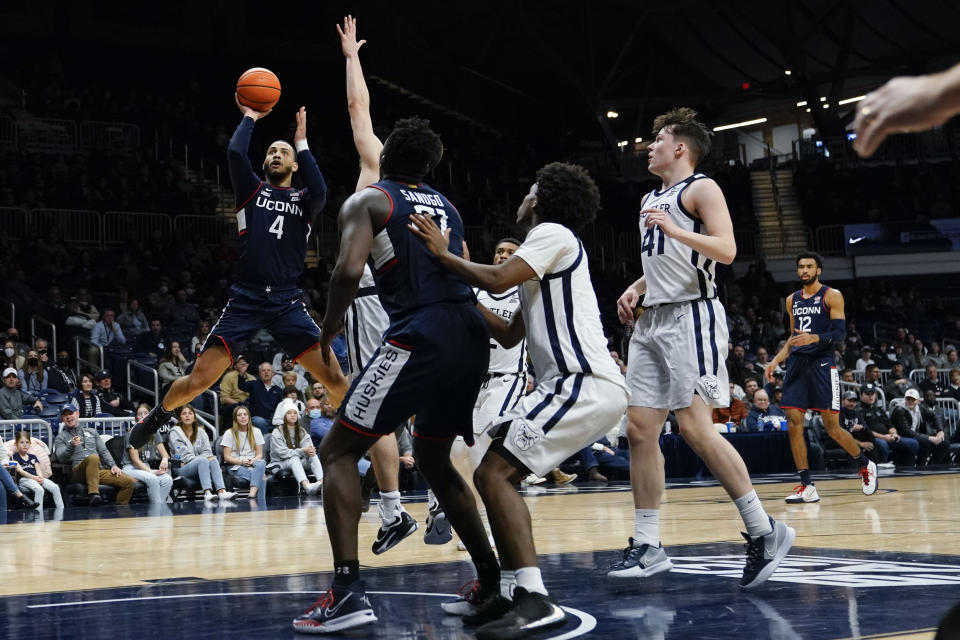 Connecticut guard Tyrese Martin (4) shoots over the defense of Butler in the second half of an NCAA college basketball game in Indianapolis, Thursday, Jan. 20, 2022. (AP Photo/AJ Mast)