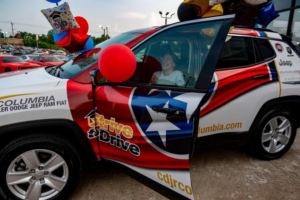 Mallori McKinney, winner of the 2022 Jeep Compass, laughs in joy as she sits in her new car for the first time on Saturday, May, 21, 2022, during the Strive to Drive giveaway held in Columbia.