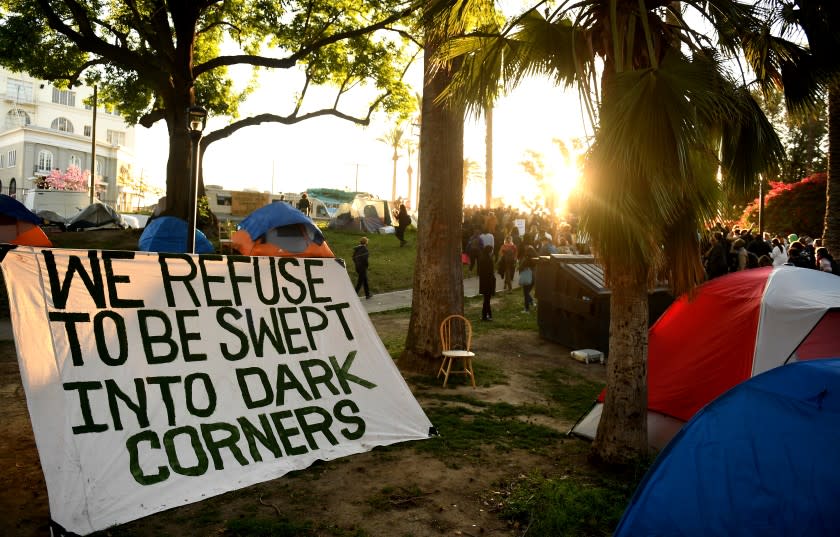 LOS ANGELES CALIFORNIA MARCH 24, 2021-A sign sits among tents for thehomeless during a rally in Echo Park Wednesday. Homeless advocates held a rally to stop the the shutdown of L.A.'s largest sel-run homeless park. (Wally Skalij/Los Angeles Times)