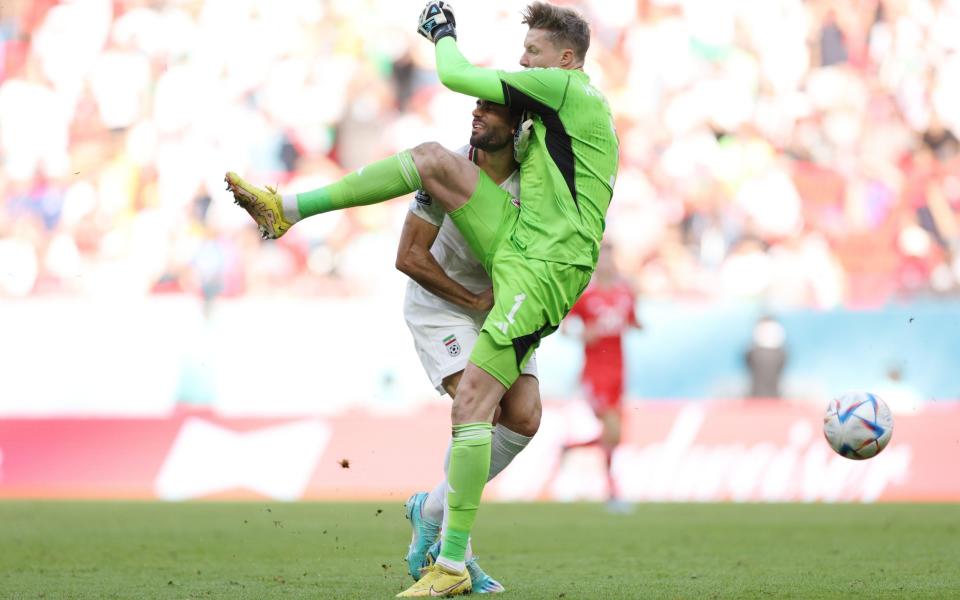 Mehdi Taremi of IR Iran is fouled by Wayne Hennessey of Wales during the FIFA World Cup Qatar 2022 Group B match between Wales and IR Iran a - Patrick Smith/Getty Images