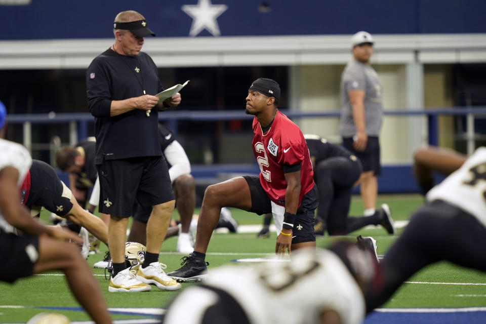 New Orleans Saints quarterback Jameis Winston (2) stretches with teammates as head coach Sean Payton walks past during NFL football practice in Arlington, Texas, Tuesday, Aug. 31, 2021. (AP Photo/LM Otero)