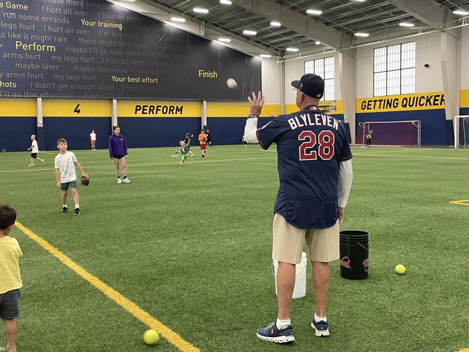 Bert Blyleven plays catch with a youngster Thursday morning at the Sanford Fieldhouse