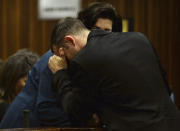 Oscar Pistorius sits in the dock in court in Pretoria, South Africa, Friday, March 14, 2014 during his murder trial. Pistorius is charged with the shooting death of his girlfriend Reeva Steenkamp, on Valentines Day in 2013. (AP Photo/Phill Magakoe, Pool)