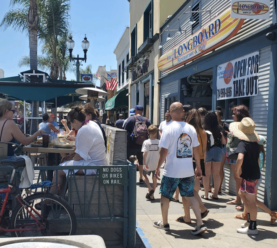 Ten miles south, in Huntington Beach, the streets and restaurants were full. (Yahoo)