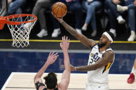 Utah Jazz forward Royce O'Neale (23) goes to the basket as San Antonio Spurs forward Drew Eubanks defends during the first half of an NBA basketball game Wednesday, May 5, 2021, in Salt Lake City. (AP Photo/Rick Bowmer)