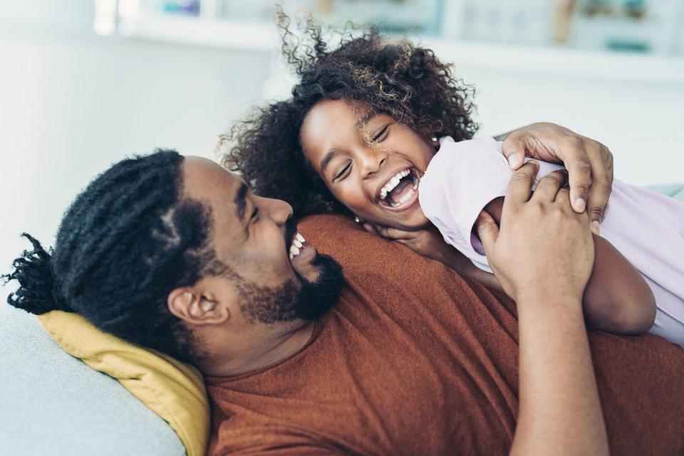 father and daughter laughing and spending time together