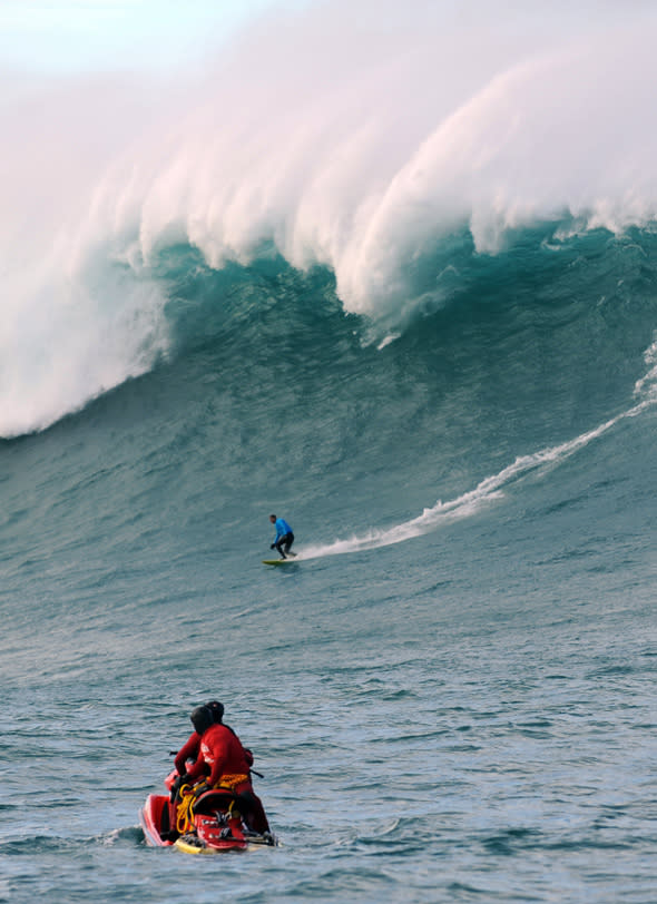 A man surfs the Belharra giant waves some two kilometers off the coast of the French basque country town of Urrugne on January 7, 2014. Thanks to certain climatic conditions in autumn and winter, a strong swell hits the Belharra Perdun underwater spur enabling a 10 to 15 metre wave to form. This wave is only surfed by experts who are towed out by a water scooter.    AFP PHOTO / GAIZKA IROZ        (Photo credit should read GAIZKA IROZ/AFP/Getty Images)