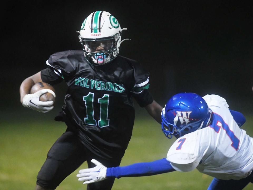 Griswold's Joshua Turner gets by Waterford's Alex Hightower for a gain during their game last season in Griswold.