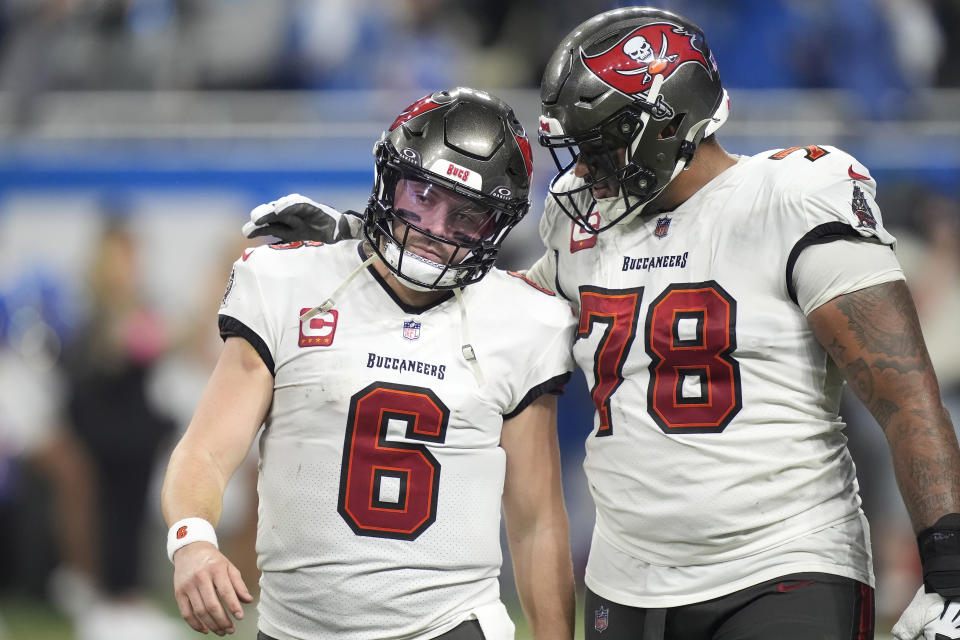 Tampa Bay Buccaneers quarterback Baker Mayfield (6) and offensive tackle Tristan Wirfs (78) walk to the bench after a pass by Mayfield was intercepted by the Detroit Lions during the second half of an NFL football NFC divisional playoff game, Sunday, Jan. 21, 2024, in Detroit. The Lions won 31-23. (AP Photo/Carlos Osorio)