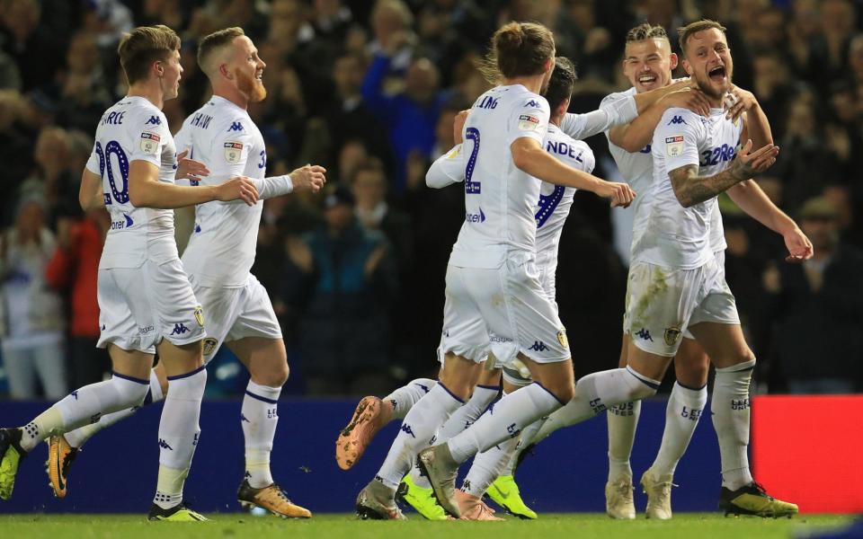 Liam Cooper celebrates Leeds' second goal as they headed top of the Championship - PA