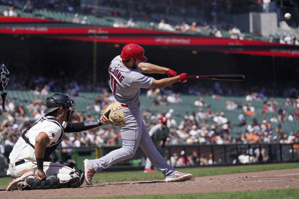 St. Louis Cardinals' Paul DeJong (11) hits a two-run home run in front of San Francisco Giants catcher Blake Sabol during the eighth inning of a baseball game in San Francisco, Thursday, April 27, 2023. (AP Photo/Jeff Chiu)