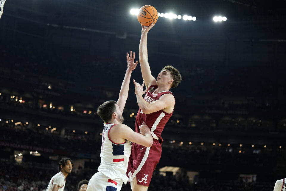 Alabama forward Grant Nelson, right, shoots over UConn forward Alex Karaban during the second half of the NCAA college basketball game at the Final Four, Saturday, April 6, 2024, in Glendale, Ariz. (AP Photo/Brynn Anderson )