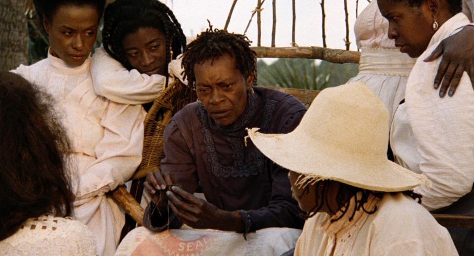 Trula Hoosier sitting and surrounded by other women