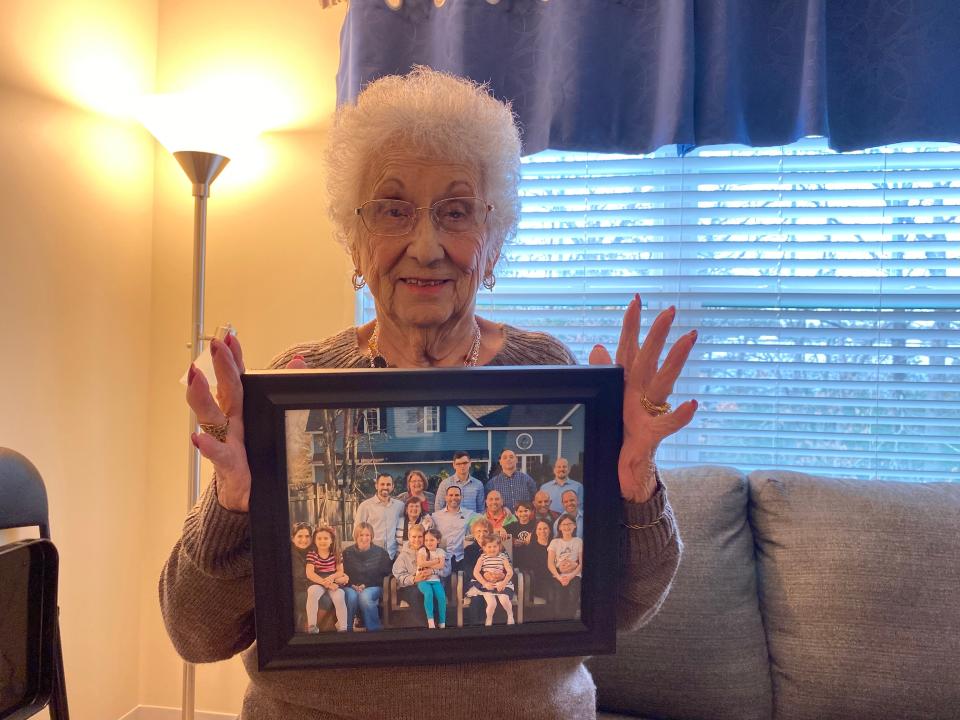 On March 27, 2024, Alice Perry, a lifelong Taunton resident, who will turn 100 on April 8, 2024, holds picture of her sons' families in her apartment at The Residence at Great Woods in Norton, where she moved only last year.