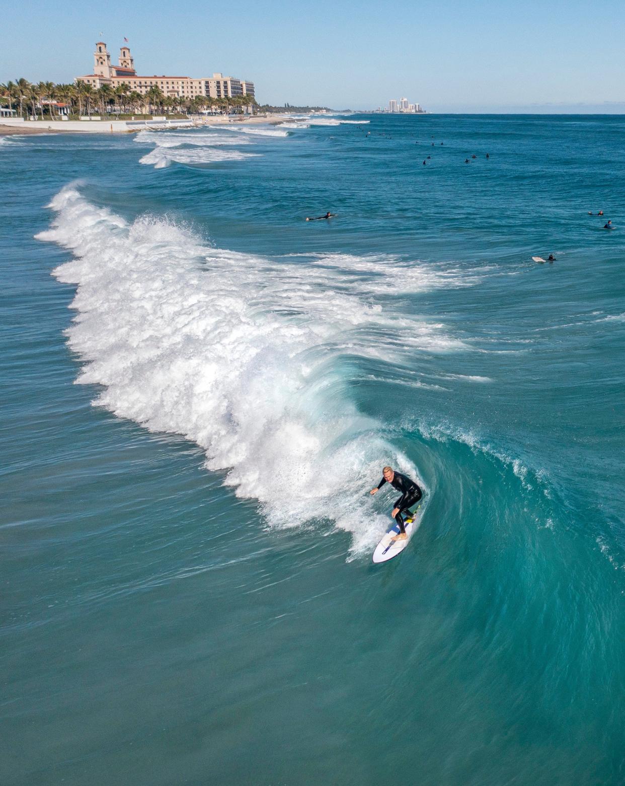 A surfer rides in the pocket of a wave at Midtown Beach in Palm Beach, Florida on Jan. 15, 2023. The Florida Department of Health in Palm Beach County on April 30 issued a no-swim advisory for Midtown Beach after high levels of bacteria were found in the water during routine testing on April 29.