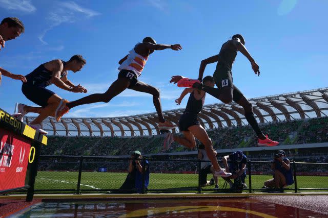 Donn Cabral, Sean McGorty and Hillary Bor race over the water jump in the steeplechase during the US Olympic Team Trials at Hayward Field.