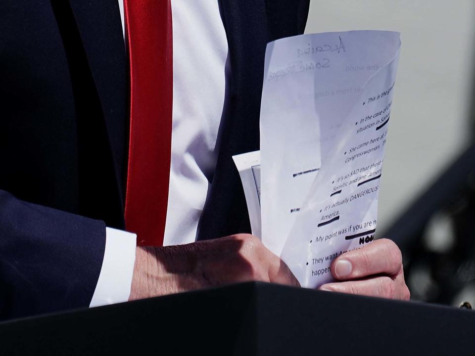 Donald Trump inadvertently exhibited his handwritten notes during a speech, revealing how he planned to attack four Democratic congresswomen – as well as a glaring spelling error which has been ridiculed online.The US president brandished a piece of paper with a list of prompts during his latest racist rant outside the White House on Monday.Pictures taken by Washington Post photographer Jabin Botsford showed a scribbled note about “Alcaida”, seemingly a phonetic misspelling of Al-Qaeda.The note was an apparent reminder to Mr Trump to smear Democratic congresswoman Ilhan Omar, who the president falsely accused during his speech of praising the Islamist terror group.Ms Omar, the Minnesota representative, is one of four Democratic women of colour who have been repeatedly targeted by Mr Trump in recent days. > @realDonaldTrump notes today on @AOC and @IlhanMN flipped and rotated for your viewing pleasure. pic.twitter.com/42sdbsRivQ> > — Jabin Botsford (@jabinbotsford) > > July 15, 2019In his address on Monday, he doubled down on his racist attacks and suggested the congresswomen should “leave right now” instead of “complaining” about the US.He had previously said: “Why don’t they go back and help fix the totally broken and crime infested places from which they came.” All four are American citizens and three were born in the US.Mr Trump’s notes, which were mostly typed out and printed, also reminded him to state “this is the greatest country in the world” and that “in the case Ohmar [sic] we saved her from a dangerous situation in Somalia”.“She came here at 10 years old and is now a Congresswoman. That would ONLY happen in America,” they add. “It’s so SAD that these women have a record of saying anti-Semitic and anti-American things all the name,” another prompt read. “It’s actually DANGEROUS – because it seems like they hate America.”Another handwritten note said “some people”, while another appeared to say “Hollywood people”.But it was Mr Trump’s erroneous spelling of the name of one of the world’s most well-known terror groups which attracted attention on social media.“Only a person who hasn’t read any newspaper articles or briefing papers in the last 20 years would not know how to spell Al Qaeda,” tweeted journalist Helen Kennedy.Nada Bakos, a former CIA anaylst, said: “How you know Potus doesn’t read anything the experts provide.”