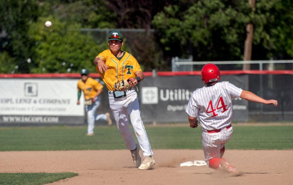 Tracy's Daniel Behrmann, left, runs a double play as Lincoln's Louis Montes is out a second during a varsity baseball game at Lincoln High School in Stockton. CLIFFORD OTO/THE STOCKTON RECORD