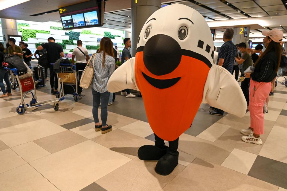 A mascot welcomes passengers upon their arrival at the reopened Singapore Changi Airport Terminal 4 in Singapore on September 13, 2022, following its closure for more than two years due to the COVID-19 pandemic. Domestic and international travel is nearing pre-pandemic levels as countries increasingly lift their pandemic-related travel restrictions. (Photo by ROSLAN RAHMAN/AFP via Getty Images)