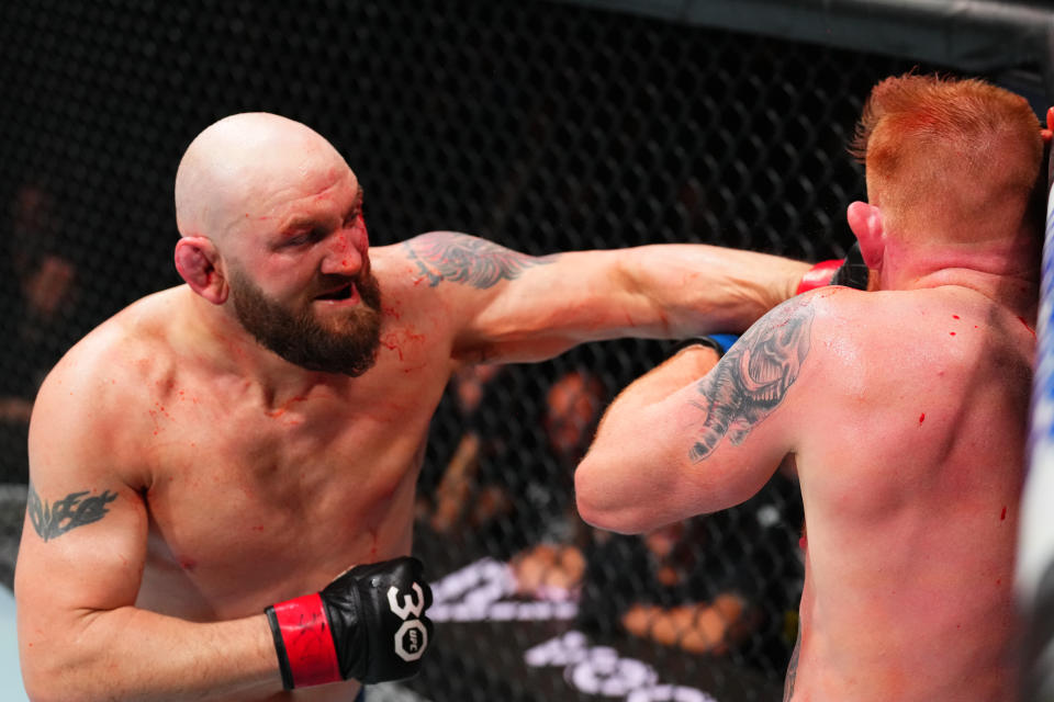 KANSAS CITY, MISSOURI - APRIL 15: (L-R) Zak Cummings punches Ed Herman in a light heavyweight fight during the UFC Fight Night event at T-Mobile Center on April 15, 2023 in Kansas City, Missouri. (Photo by Josh Hedges/Zuffa LLC via Getty Images)