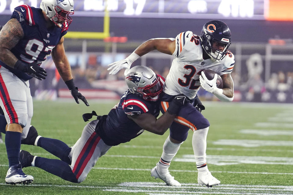 Chicago Bears running back David Montgomery (32) tries to break free from New England Patriots linebacker Ja'Whaun Bentley during the second half of an NFL football game, Monday, Oct. 24, 2022, in Foxborough, Mass. (AP Photo/Steven Senne)