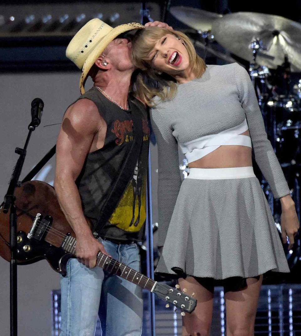 <p>Rick Diamond/Getty</p> Kenny Chesney and Taylor Swift in Nashville in March 2015