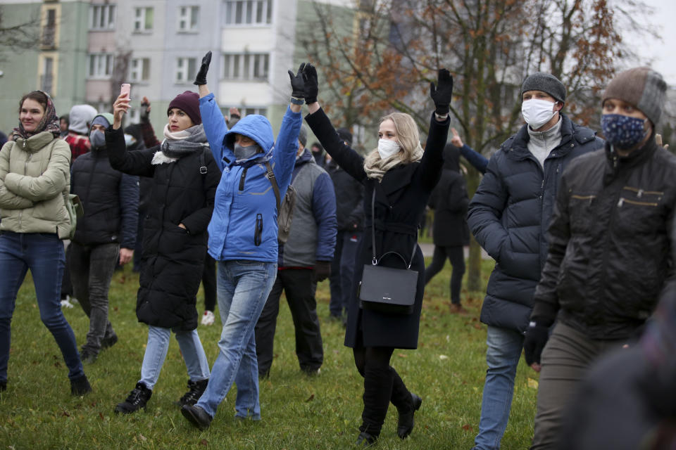 Demonstrators wearing face masks to help curb the spread of the coronavirus gesture during an opposition rally to protest the official presidential election results in Minsk, Belarus, Sunday, Nov. 22, 2020. The Belarusian human rights group Viasna says more than 140 people have been arrested and many of them beaten by police during protests calling for the country's authoritarian president to resign. The demonstrations that attracted thousands were the 16th consecutive Sunday of large protests against President Alexander Lukashenko. (AP Photo)