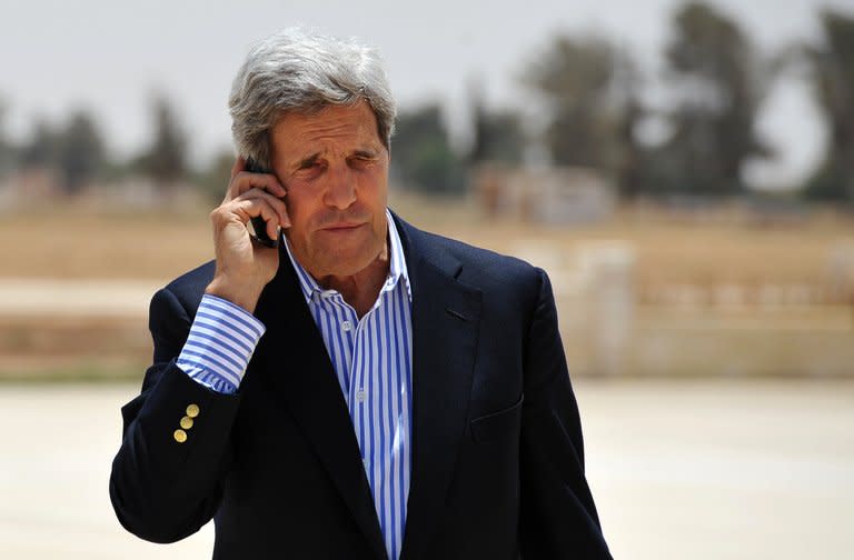 US Secretary of State John Kerry speaks on the phone at Mafraq air base before boarding a helicopter to Amman, after visiting Zaatari refugee camp in Jordan on July 18, 2013. Kerry Friday met with chief Palestinian negotiator Saeb Erakat in a final push to get a peace bid back on track before heading home