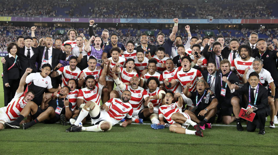 Japan players and management celebrate after defeating Scotland 28-21 in their Rugby World Cup Pool A game at International Stadium in Yokohama, Japan, Sunday, Oct. 13, 2019. (AP Photo/Christophe Ena)