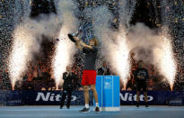 Tennis - ATP Finals - The O2, London, Britain - November 18, 2018 Germany's Alexander Zverev celebrates with the trophy after winning the final as second placed Serbia's Novak Djokovic (R) looks on holding his trophy Action Images via Reuters/Andrew Couldridge
