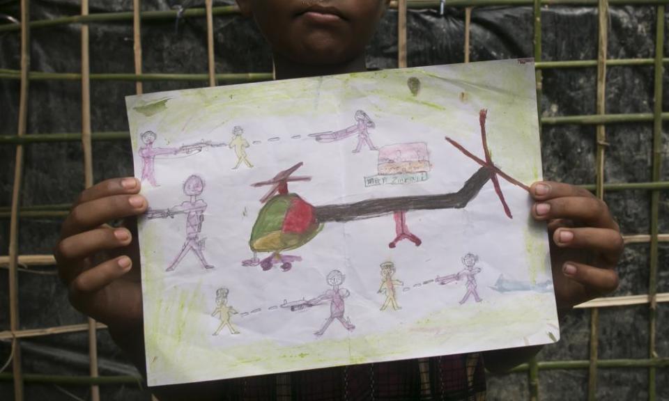 Manzur Ali,an 11-year-old Rohingya refugee who fled to Bangladesh, shows a drawing