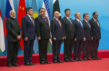 Russian President Vladimir Putin is seen during a photo session of the SCO (Shanghai Cooperation Organisation) Heads of State ahead of a meeting of the SCO Council of Heads of State in Qingdao, China June 10, 2018. (L-R): Prime Minister of the Republic of India Narendra Modi, President of the Kyrgyz Republic Sooronbay Jeenbekov, President of the Republic of Tajikistan Emomali Rahmon, Russian President Vladimir Putin, President of the People's Republic of China Xi Jinping, President of the Republic of Kazakhstan Nursultan Nazarbayev, President of the Republic of Uzbekistan Shavkat Mirziyoyev and President of Republic of Pakistan Mamnoon Hussain. Sputnik/Dmitry Azarov/Kremlin via REUTERS