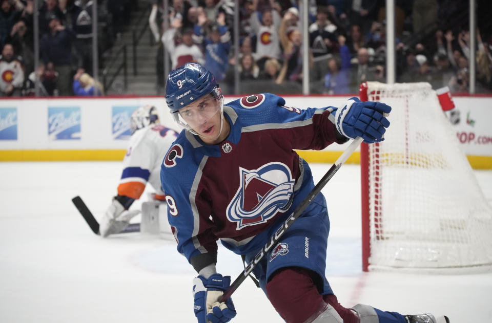 Colorado Avalanche center Evan Rodrigues, front, reacts after scoring a goal against New York Islanders goaltender Ilya Sorokin during a shootout in an NHL hockey game Monday, Dec. 19, 2022, in Denver. (AP Photo/David Zalubowski)