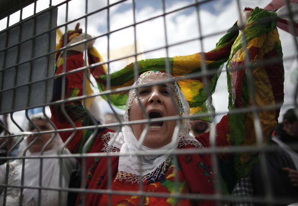 FILE-In this Sunday, March 24, 2019 file photo, a woman shouts as thousands of supporters of pro-Kurdish Peoples' Democratic Party, or HDP, gather to celebrate the Kurdish New Year and to attend a campaign rally in Istanbul, ahead of local elections scheduled for March 31, 2019. Millions of Kurdish votes could be crucial in determining the outcome of the elections, being held amid a heavy government crackdown on the HDP for alleged links to outlawed Kurdish militants.(AP Photo/Emrah Gurel, File)