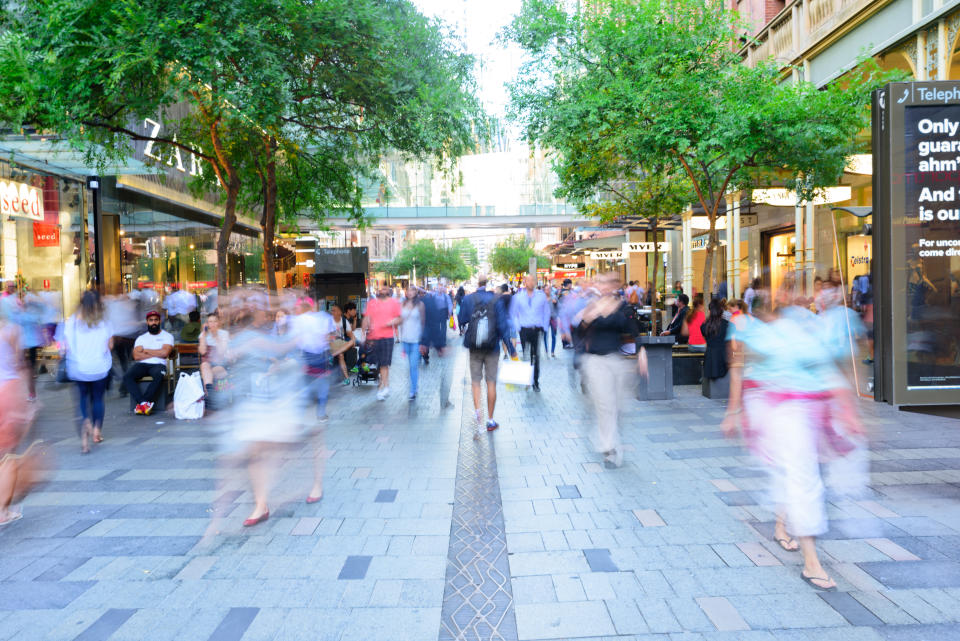 Sydney, Australia - November 10, 2015: Blurred people shoppers in central Sydney a nice summer day. Various signs, mix of people crowd, all zoom blurred. Blur made in lens, not post processing.