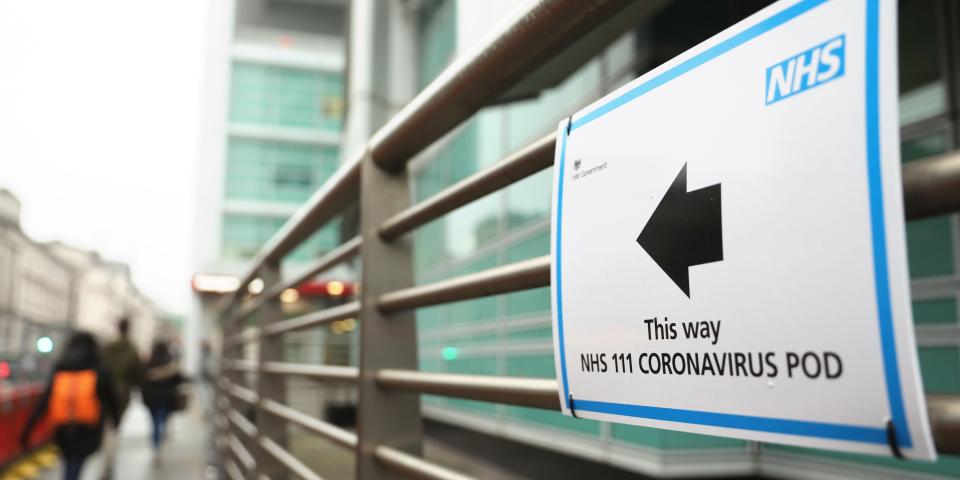 A sign directs directs patients to an NHS 111 Coronavirus Pod testing service area for COVID 19 assessment at University College Hospital in London on March 5, 2020. ISABEL INFANTES:AFP via Getty Images)