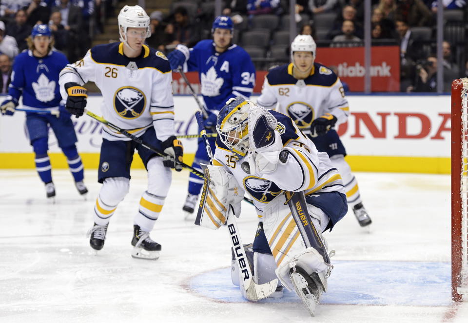 Buffalo Sabres goaltender Linus Ullmark (35) makes a save against the Toronto Maple Leafs during second period NHL hockey action in Toronto on Tuesday, Dec. 17, 2019. (Nathan Denette/The Canadian Press via AP)