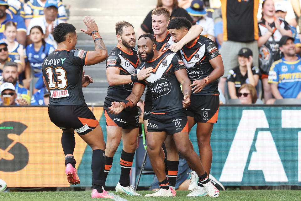 SYDNEY, AUSTRALIA - APRIL 01:  Justin Olam of the Tigers celebrates with team mates after scoring a try during the round four NRL match between Parramatta Eels and Wests Tigers at CommBank Stadium, on April 01, 2024, in Sydney, Australia. (Photo by Matt King/Getty Images)