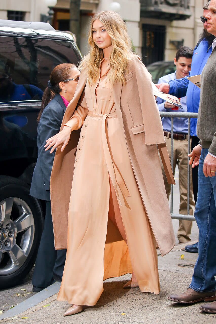 Gigi Hadid wears a peach jumpsuit and overcoat while leaving a taping of “Live With Kelly and Michael.”