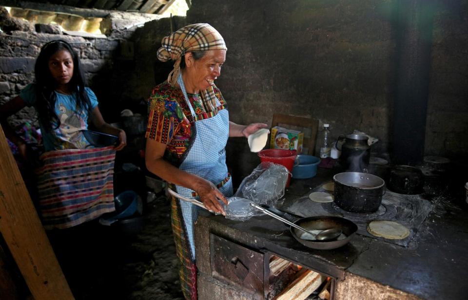 Angela Lopez, 53, makes tortillas for lunch with her 13-yr. old daughter Liliana Adriana Lopez at her home near Comitancillo